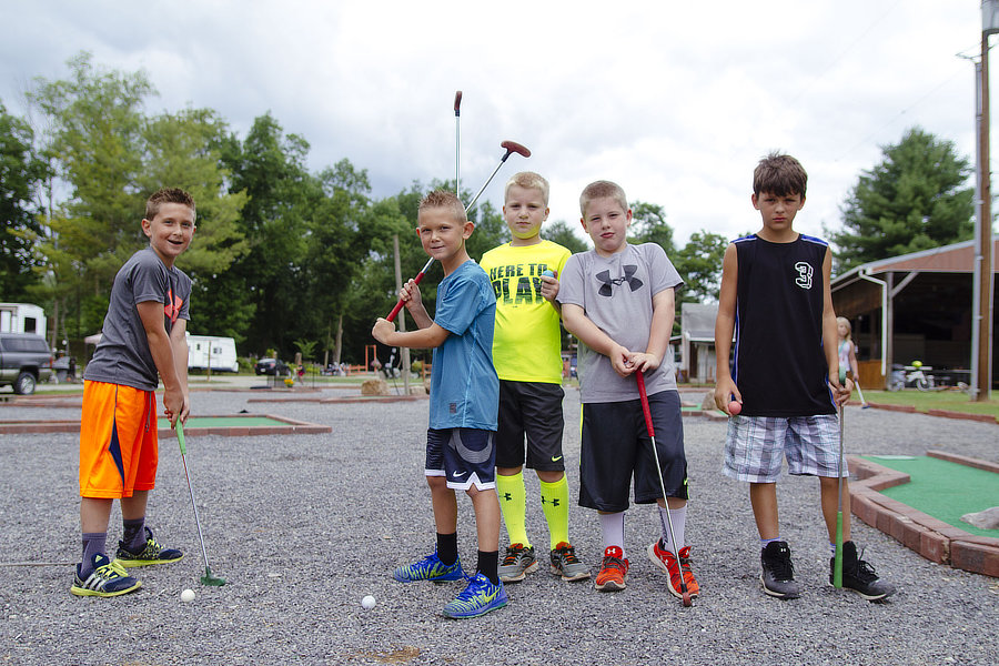 Kids playing mini golf