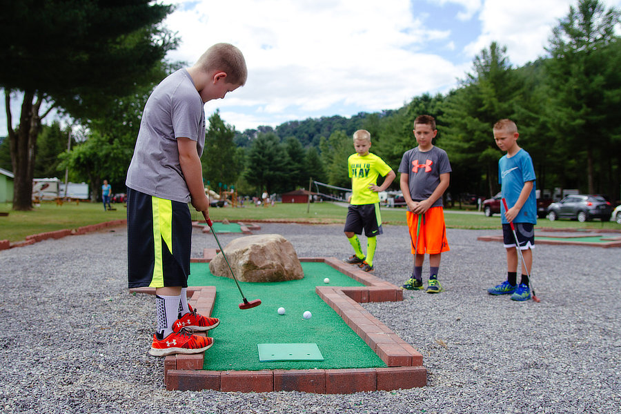 Kids playing mini golf